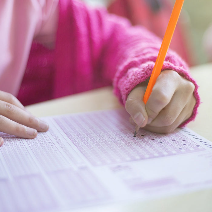 student taking test with wholesale school supplies
