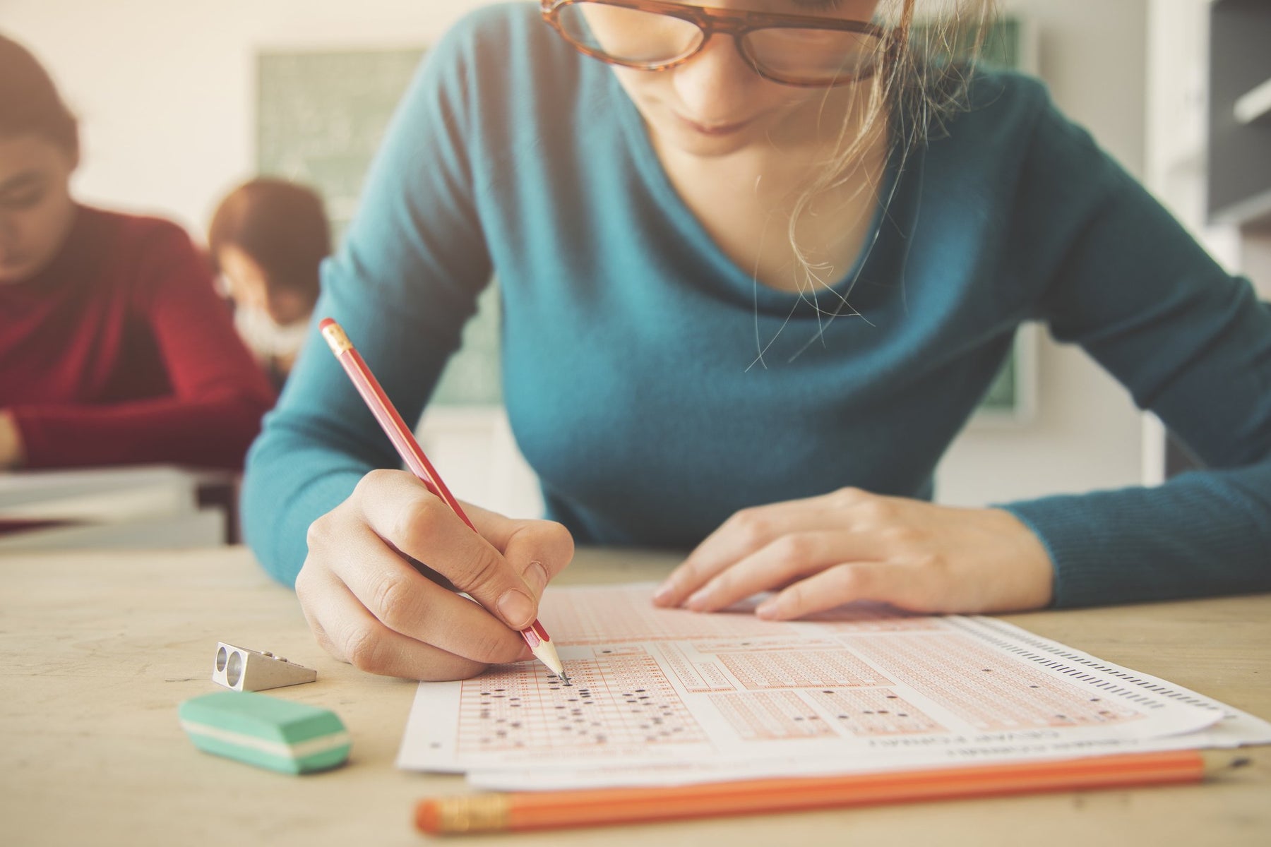 female students takes test with wholesale school supplies